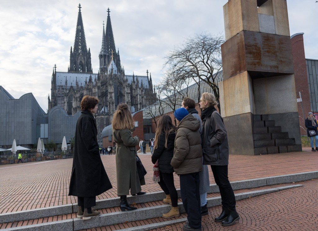 Sechs Frauen stehen auf dem Platz vor dem Museum Ludwig und schauen auf den Kölner Dom